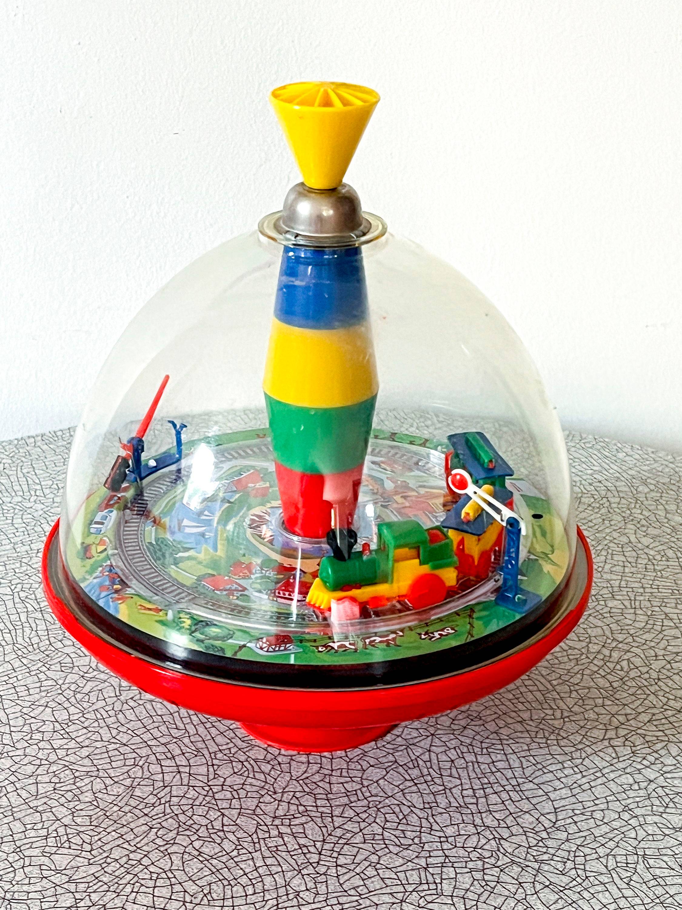 Toupie vintage de collection avec train en tôle et plastique